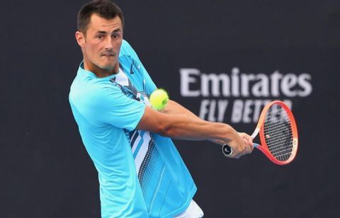 Bernard Tomic with a shot at the tennis ball.